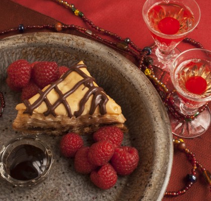 Chocolate Baklava and Organic Raspberries on a red background for Valentine's Day