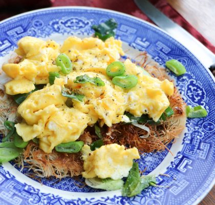 Scrambled eggs over a bed of scallions and kataifi